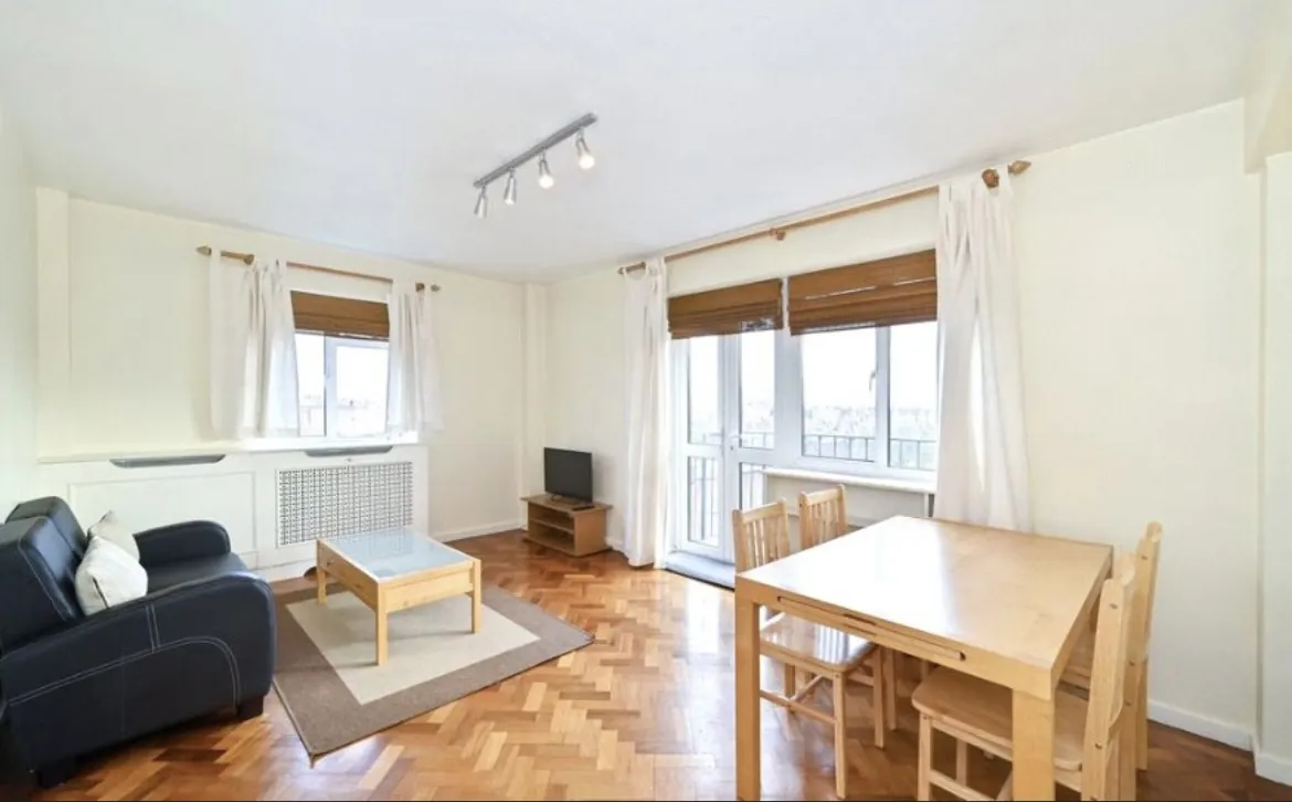 Living and dining room with a balcony door and wooden floors